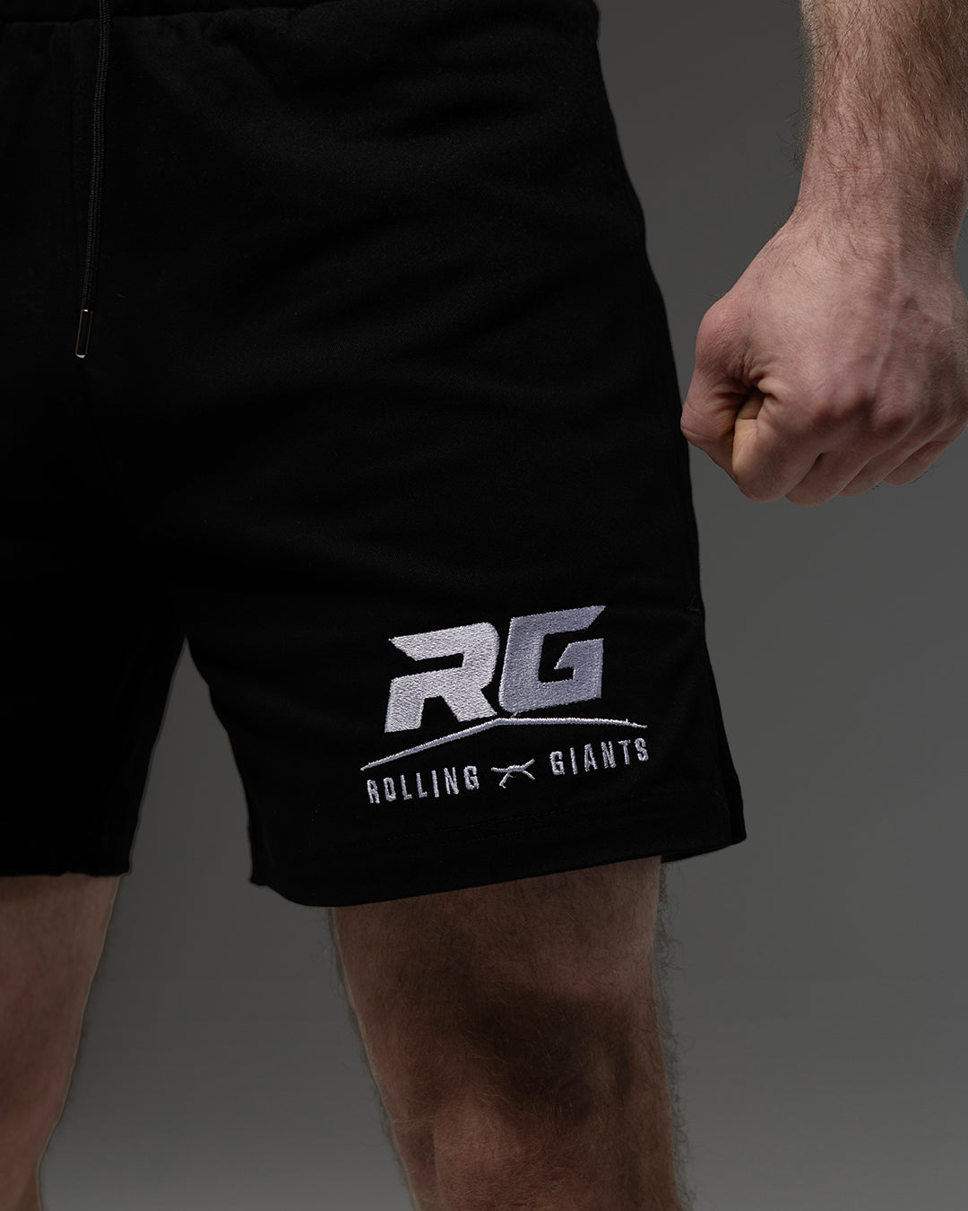 Black RG Fight Shorts by Rolling-Giants with adjustable waistband and reinforced stitching for MMA training and competition.