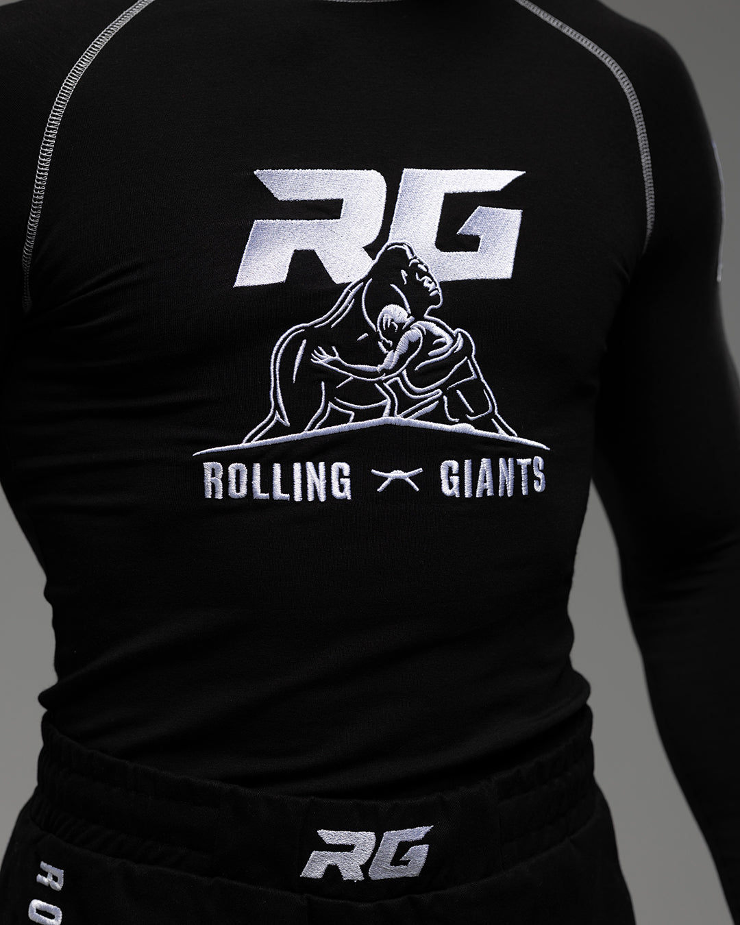 Black RG NaturaFlex™ Rash Guard by Rolling-Giants with long sleeves, fitted for athletic training and water sports.