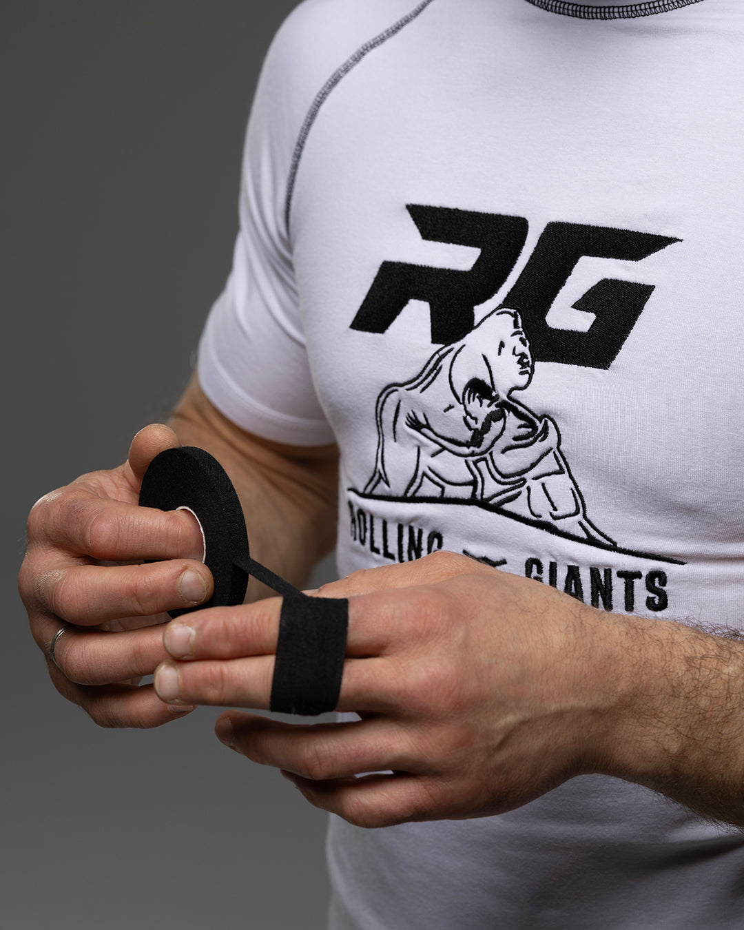 Black RG Cotton Zinc Oxide Finger Tape by Rolling-Giants, shown in four rolls, ideal for finger support and protective taping.